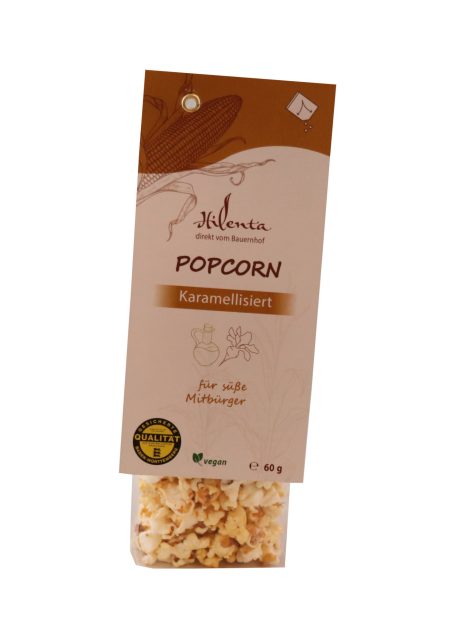Popcorn in durchsichtiger Verpackung mit beige-farbenem Etikett und grüner Bio-Kennzeichnung.